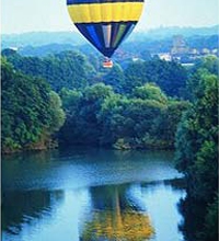hot air balloon reflected in a lake