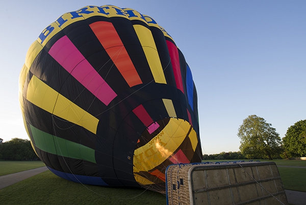 The hot air goes into the balloon and it rises up.