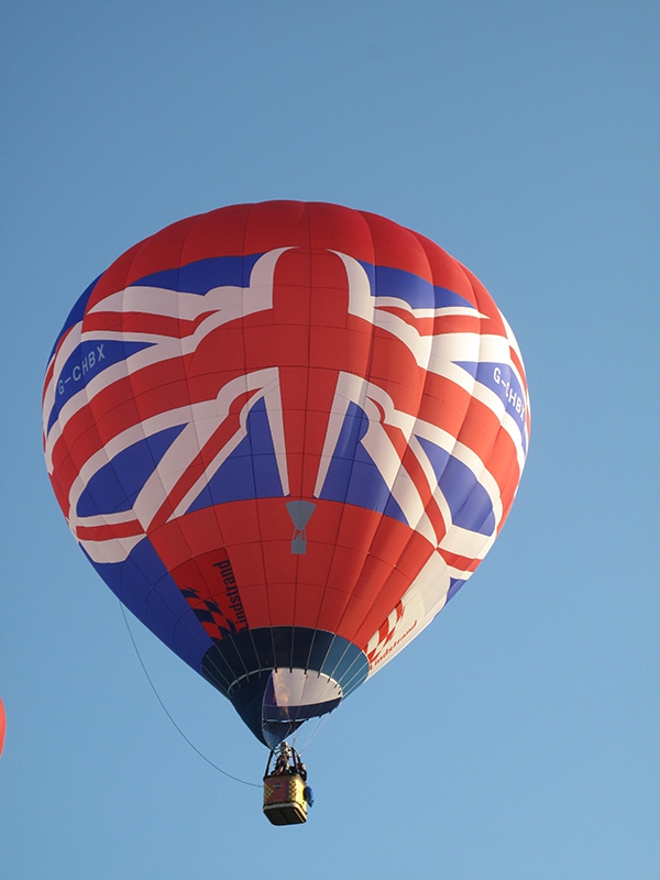 The Lindstrand Union Jack balloon has three "faces" and here it is showing it's red face to the camera. This balloon was built by Lindstrand Balloons in 2012 to mark the Queens Jubilee and its patriotic design is a real crowd pleaser.