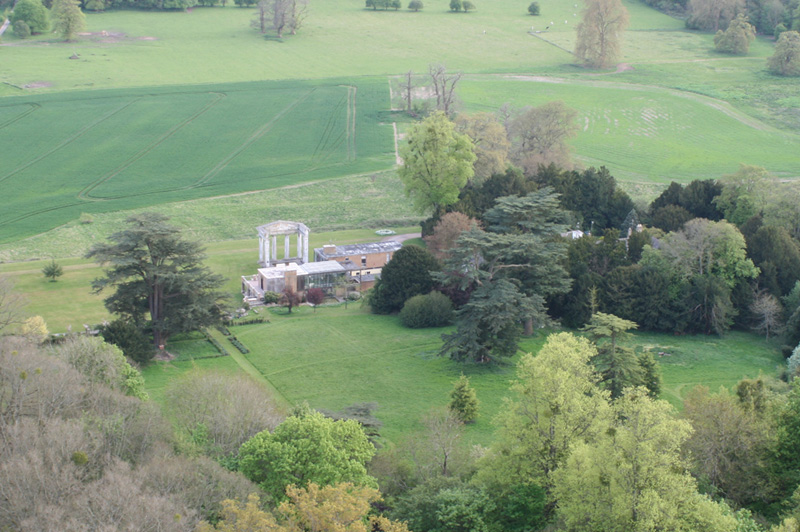 
In these aerial photographs of Stratton Park, East Stratton Hampshire you can see the doric columned portico and stuccoed main block. This is the last remaining part of the original house designed by George Dance the younger and built in 1803. The grounds laid out at the same time contain a mixture of fine specimen trees which remain to the present day. In 1963 the original house was demolished by the owner John Baring and a modernist house by Stephen Gardiner and Christopher Knight was built but with no logical relationship to the portico. This is a regular site when our balloons fly from Micheldever on a westerly wind. Go to https://en.wikipedia.org/wiki/Stratton_Park for more information and history.