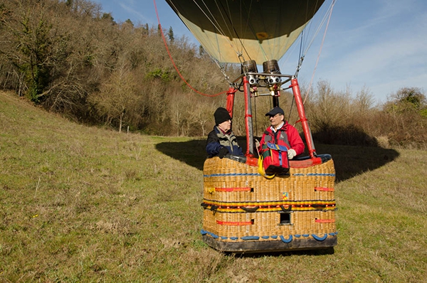 Tom and Kim wait in the balloon while Cate walks off to find the landowner