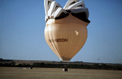 As the balloon touches down the pilot furiously pulls on the side