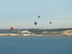 Hot air balloons flying over Dover Castle and the English Channel