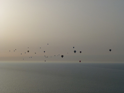 A morning sky full of hot air balloons