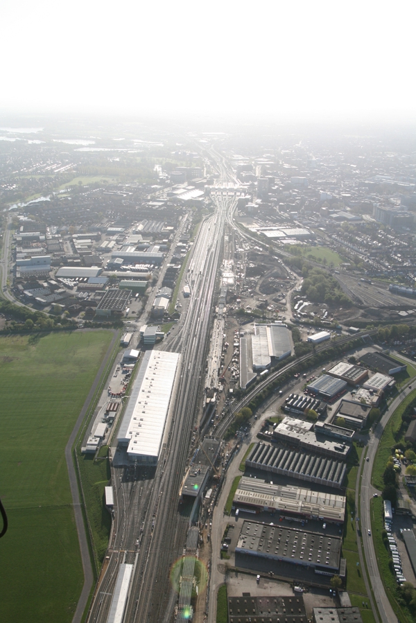 The sun glistens on the railway tracks as they feed in from the West to the centre of&nbsp;Reading&nbsp;and the railway station with part of the Reading Festival site to the left of the picture.