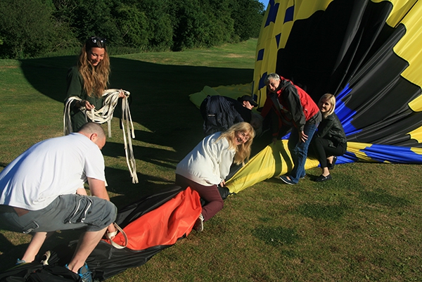 Packing away the 120 foot high hot air balloon after landing on this Oxford balloon ride is fun too!