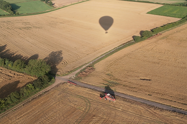 Its summer time and the combine harvesters are out in the fields cutting the crop in Essex as the balloon&rsquo;s shadow floats gently past.