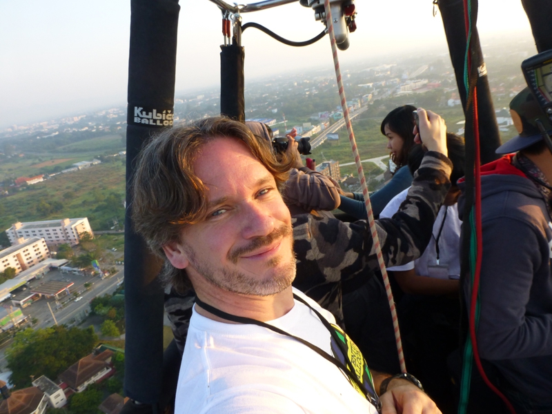 Another "selfie" as Kerry drifts over Chiang Mai in the early morning on the first official flight of the festival with Chinese TV crew on board filming the balloon festival whilst advertising Adventure Balloons on his T shirt.