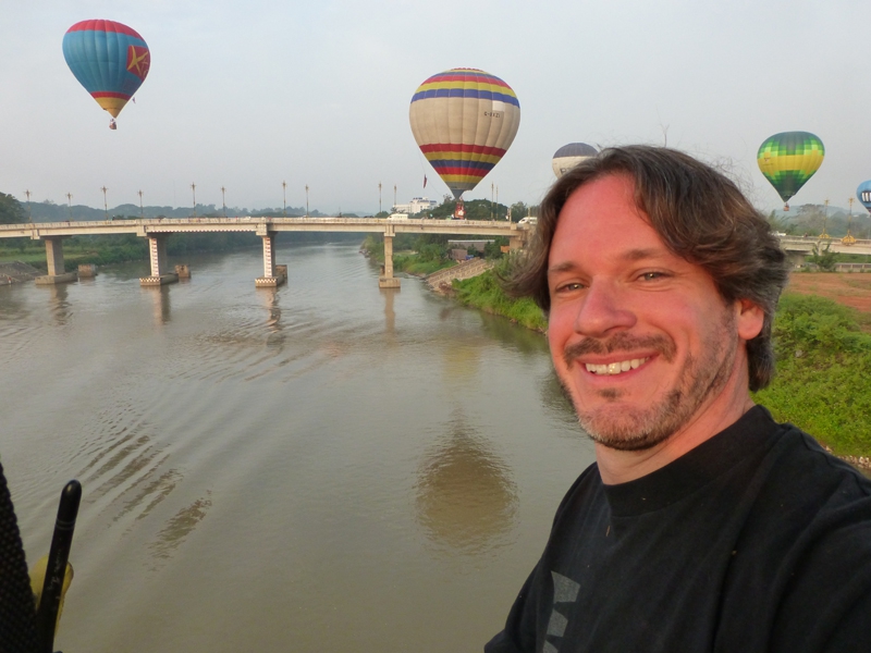 Kerry takes a “selfie” as he flies his Ford Explorer hot air balloon over the over the Kok River into Chiang Rai city, about a two hour drive north of Chiang Mai.