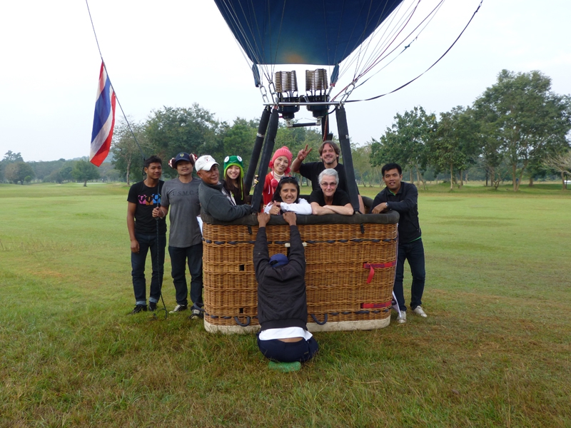 Happy balloon ride passengers, happy crew and a happy pilot! A nicer place to land the hot air balloon on a dry paddy field. The balloon is then floated to the entrance of the field while the crew pull it along and then deflated on the track leading in to the field. "That keeps the Thai farmers happy" says Kerry.