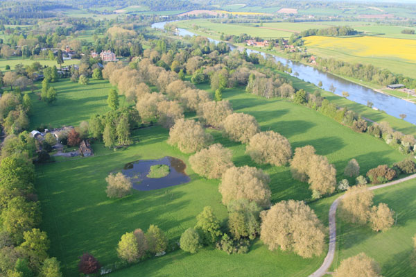 Designed by Sir Christoper Wren with garden landscaped by Capability Brown,&nbsp;Fawley Court&nbsp;is one of the grandest houses in Henley On Thames. Its current owners have recently undertaken a major renovation of the house. This aerial picture taken on hot air balloon rides from Henley shows&nbsp;Temple&nbsp;Island. This sits in the middle of the&nbsp;Thames&nbsp;just opposite the main house and was originally built as a fishing lodge for the house. It is just visible in the middle of the River as the&nbsp;Thames&nbsp;bears to the top right of the picture.