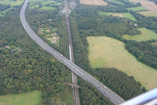 Steam Train approaches Winchfield Station on its way to Waterloo viewed from a hot air balloon.