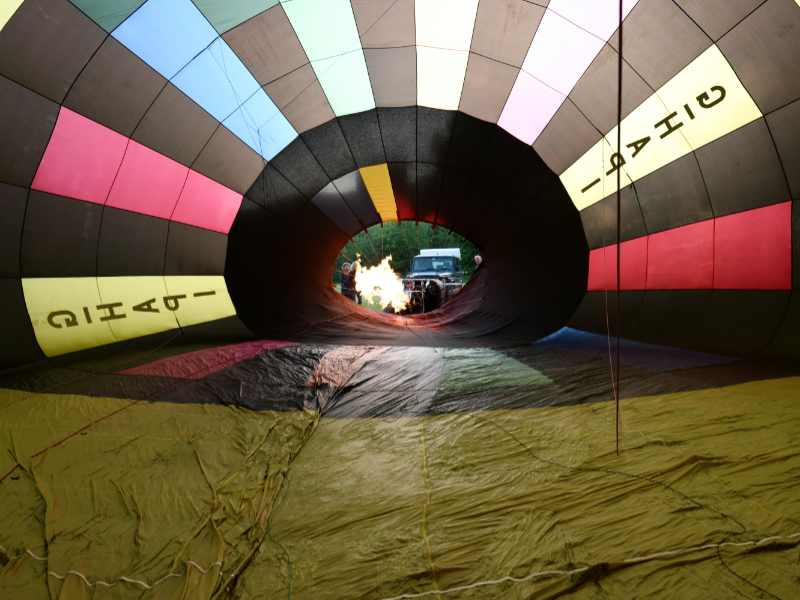A photograph from inside the hot air balloon as the burner is turned on to heat it up