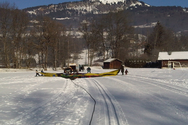 Preparing the balloon on a snow covered football playing field in France.