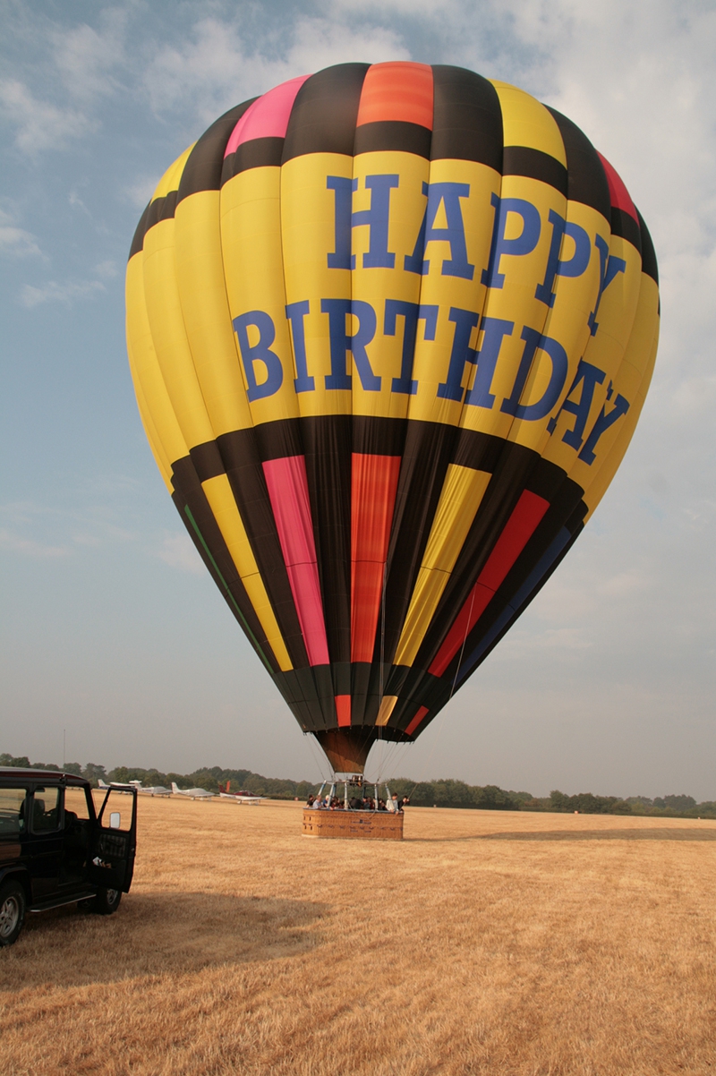 Touch down next to the aircraft at Denham in our Happy Birthday balloon after a great flight over London, Wembley and Harrow.