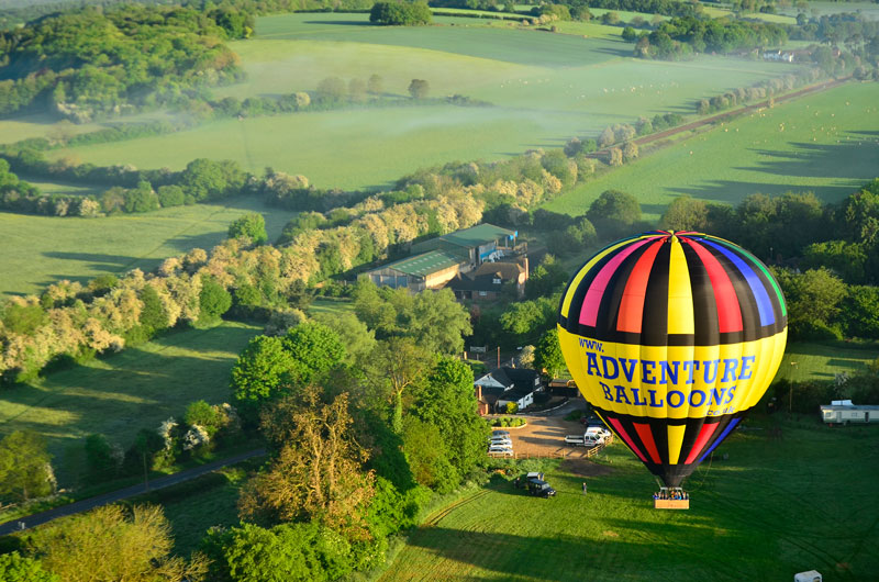 The take off by hot air balloon is a most gently experience as you notice that without any sensation of movement you are feet above the ground as the balloon rises with a few puffs of hot air from the propane burners. In the background to the left of the balloon is the Black Horse Pub which has been a mecca for balloonists in the area to the North West of London for over 30 years.