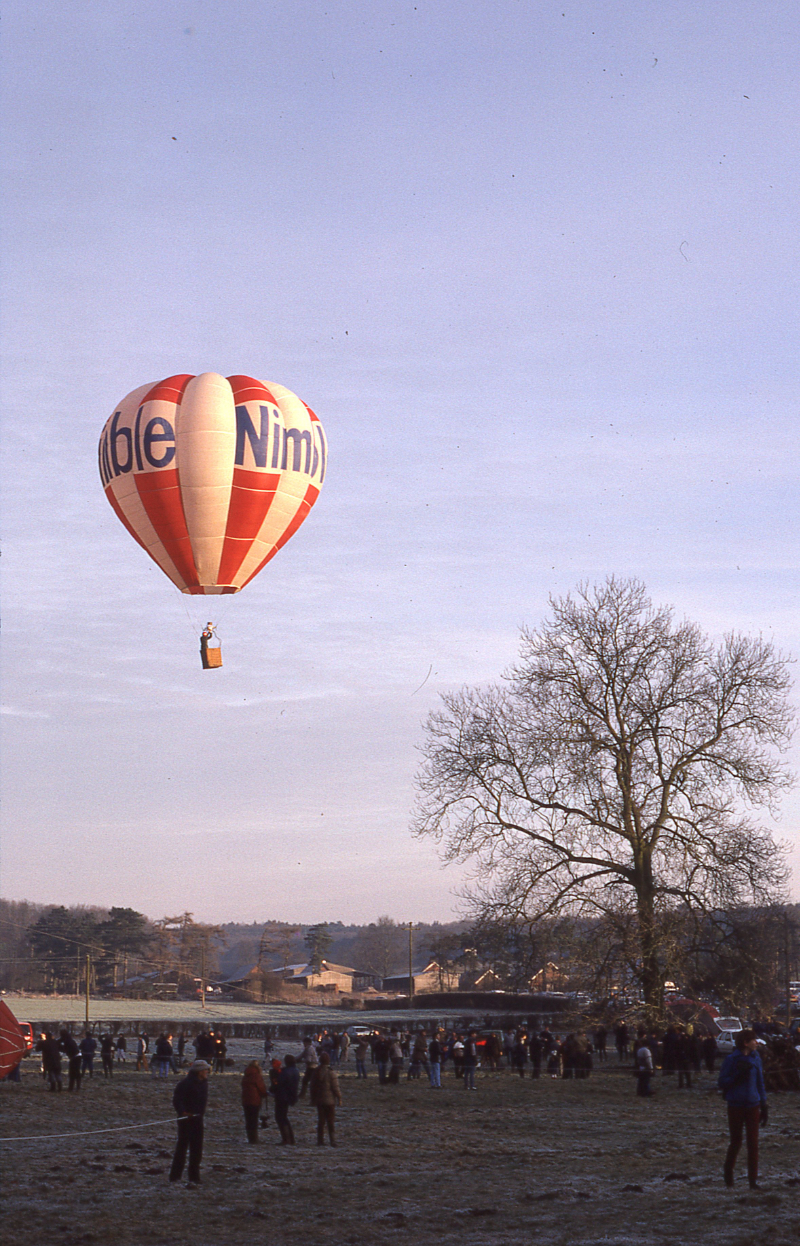 Nimble Hot air balloon history. Another picture from the archives supplied by Peter J Bish. This one of the balloon registered as G-AXMD, flying from Marsh Benham near Newbury in Berkshire on the 4th January 1986 at the Icicle Balloon meet &ndash; note the frost on the ground! An early recruit to the resurgence of ballooning in the 1970&rsquo;s, Pete sells balloon equipment and lists second hand balloons for sale. His web site www.zebedeelist.co.uk is a good point to start if you are looking for balloons or associated parts.