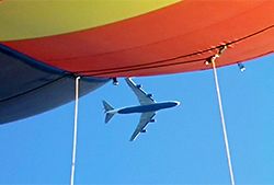 A jumbo flies overhead our balloon